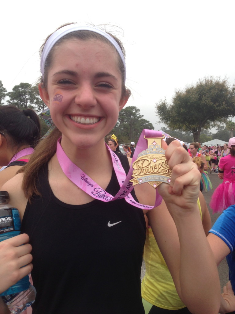Naomi at Disney Princess Half Marathon with her Medal Bling